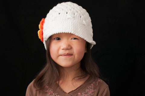 White Crocheted Flower Cap with Orange and Yellow Flower