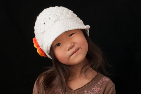 White Crocheted Flower Cap with Orange and Yellow Flower